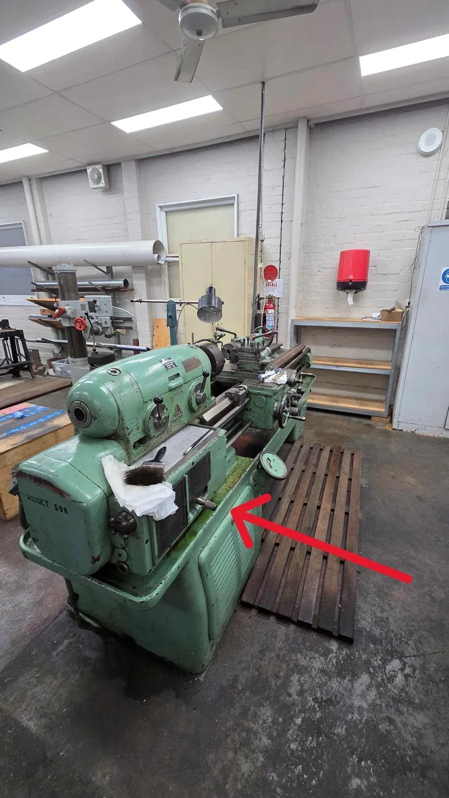 Green metalworking lathe identified in the Sydney warehouse relocation scope