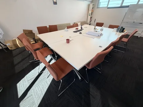 Meeting-room table, upholstered chairs and boxed items included in the office scope.