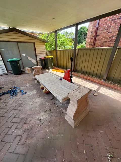 Sandstone bench and shaped stone supports in the covered outdoor area at the Brisbane house.