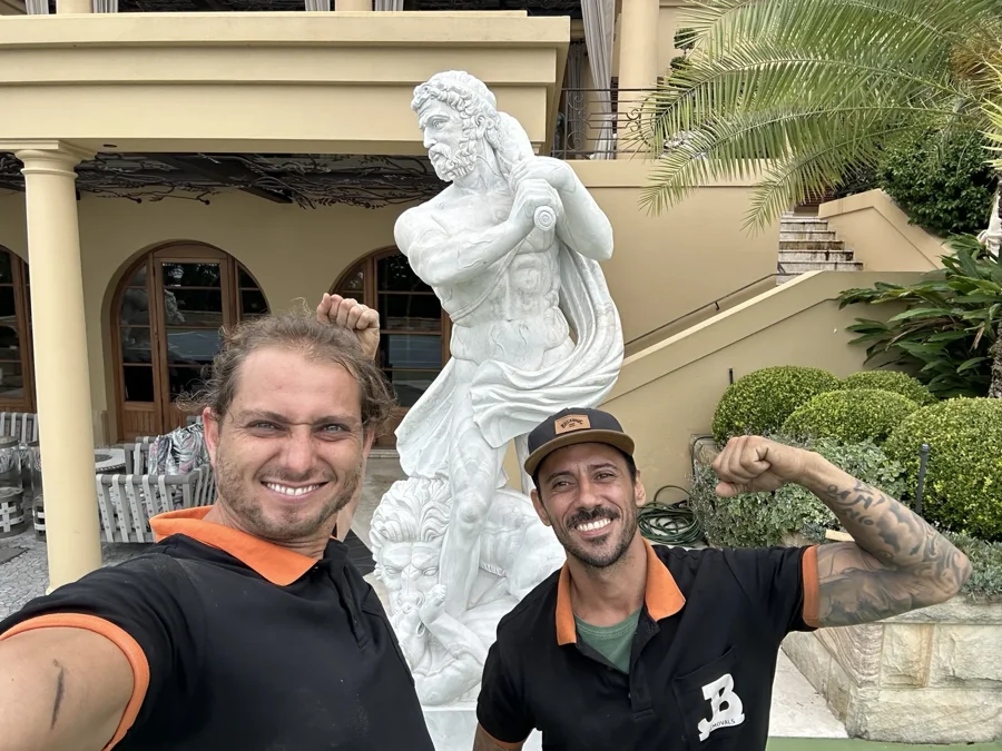 Two JB team members beside the marble statue at its Beverly Hills destination
